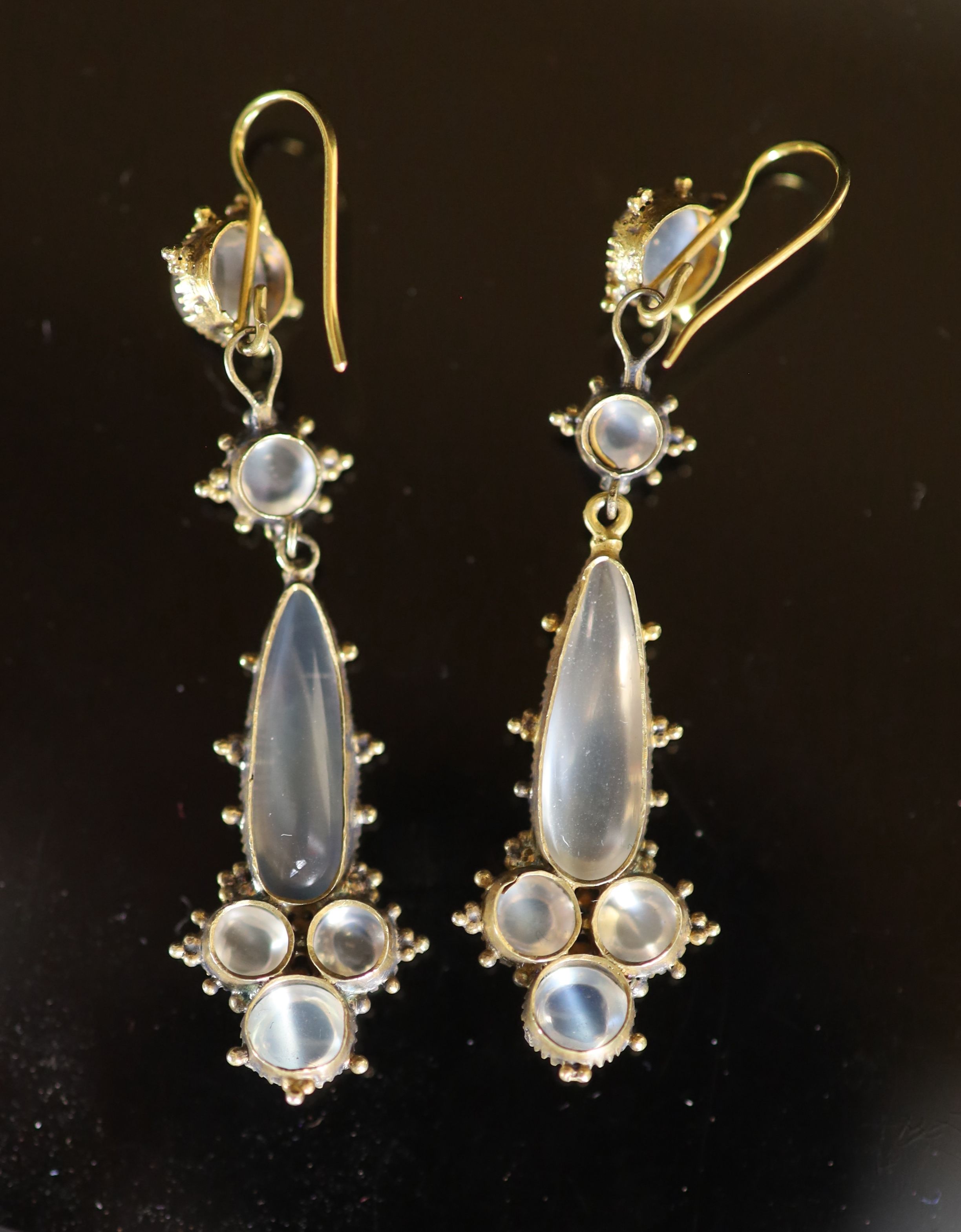 A pair of early 20th century gold and six stone cabochon moonstone set drop earrings